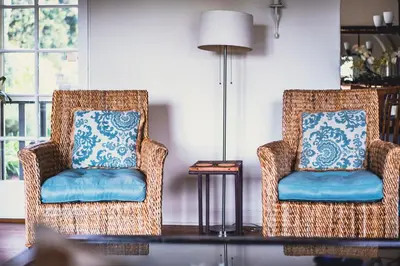 two wicker chairs with blue cushions in a living room at La Jolla Shores Oceanview Retreat in San Diego