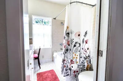 a bathroom with a shower with a shower curtain at La Jolla Shores Oceanview Retreat in San Diego