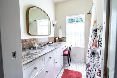 a bathroom with a sink and a mirror at La Jolla Shores Oceanview Retreat in San Diego