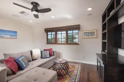 a living room with a couch and a tv at Mediterranean Beauty with Rooftop Deck and Views in San Diego