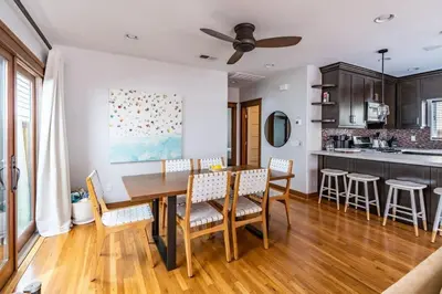a kitchen and dining room with a wooden table and chairs at Mission Beach Retreat Steps to Bay & Beach in San Diego