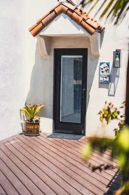 a door on a house with a wooden deck at Mission Beach Retreat Steps to Bay & Beach in San Diego