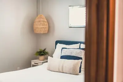 a bedroom with a bed and a potted plant at Mission Beach Retreat Steps to Bay & Beach in San Diego