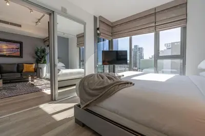 a bedroom with a large bed and a large window at Skyline Escape in the Heart of Downtown in San Diego