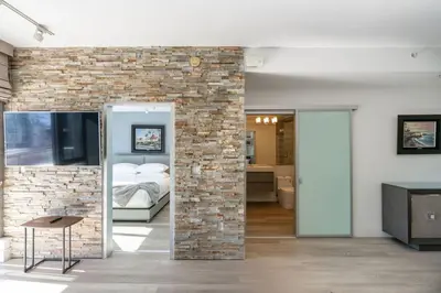 a bedroom with a brick wall and a bed at Skyline Escape in the Heart of Downtown in San Diego