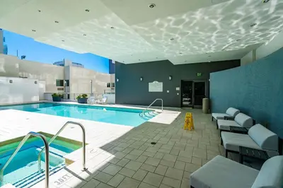 a large swimming pool with chairs and a swimming pool at Skyline Escape in the Heart of Downtown in San Diego