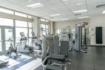 a gym with several treadmills and cardio machines at Skyline Escape in the Heart of Downtown in San Diego