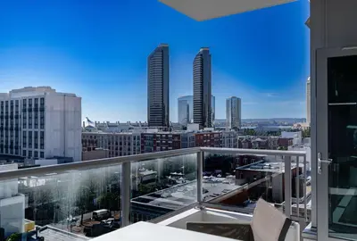 a balcony with a view of a city with tall buildings at Skyline Escape in the Heart of Downtown in San Diego