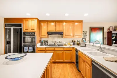 a kitchen with wooden cabinets and a white counter top at Spacious Beautiful Home with Stunning Bay Views in San Diego