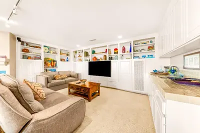 a living room with a couch and a tv at Spacious Beautiful Home with Stunning Bay Views in San Diego