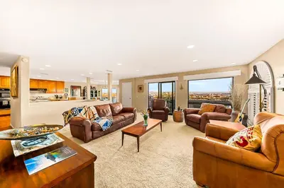 a living room with couches and a table at Spacious Beautiful Home with Stunning Bay Views in San Diego