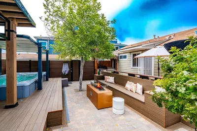 a patio with a fireplace and a swimming pool at Surfside Charmer One Block to Beach in San Diego