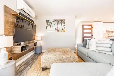 a living room with a couch and a table at Surfside Charmer One Block to Beach in San Diego