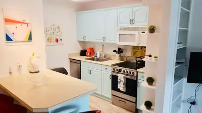 a kitchen with white cabinets and a counter top at Right In The Heart Of Pacific Beach in San Diego