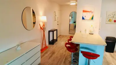 a kitchen with a counter and red chairs in a room at Right In The Heart Of Pacific Beach in San Diego