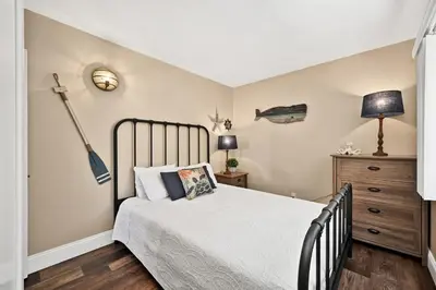 a bedroom with a bed with a baseball bat on the wall at Newport Paradise - Oceanfront Home by the Pier in Newport Beach