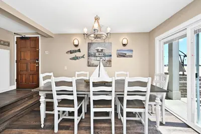 a dining room with a table and chairs at Newport Paradise - Oceanfront Home by the Pier in Newport Beach
