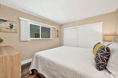 a bedroom with a bed and a window at Newport Paradise - Oceanfront Home by the Pier in Newport Beach