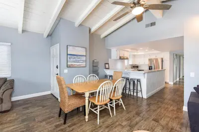 a dining room and kitchen with a table and chairs at 5 Bedroom Home with Pool Table steps to the Beach in Newport Beach