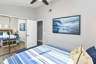 a bedroom with a bed and a tv on the wall at 5 Bedroom Home with Pool Table steps to the Beach in Newport Beach