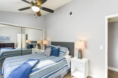 a bedroom with two beds and a ceiling fan at 5 Bedroom Home with Pool Table steps to the Beach in Newport Beach