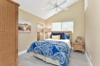 a bedroom with a bed and a ceiling fan at Multi Level Oceanfront Home with Patio on the Beach, Fire pit and 2 car garage in Newport Beach