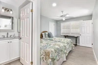 a bedroom with a bed and a sink at Multi Level Oceanfront Home with Patio on the Beach, Fire pit and 2 car garage in Newport Beach