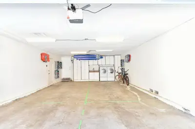 an empty garage with a bike parked in it at Multi Level Oceanfront Home with Patio on the Beach, Fire pit and 2 car garage in Newport Beach