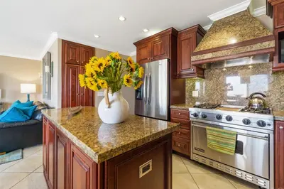 a kitchen with a vase with yellow flowers on a counter at 3 Bedroom Home in Balboa - Walk to Pier & Restaurants in Newport Beach
