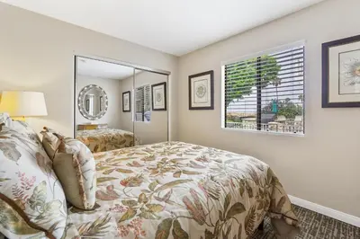 a bedroom with a bed and a mirror at 3 Bedroom Home in Balboa - Walk to Pier & Restaurants in Newport Beach