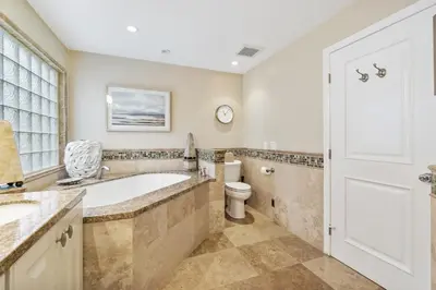 a bathroom with a tub and a toilet at 3 Bedroom Home in Balboa - Walk to Pier & Restaurants in Newport Beach
