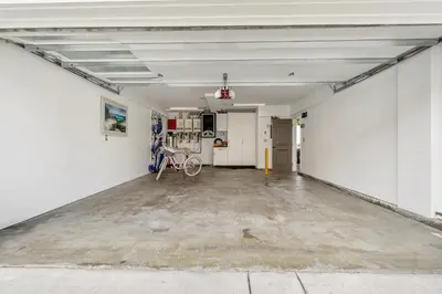an empty garage with a bike in the middle at 3 Bedroom Home in Balboa - Walk to Pier & Restaurants in Newport Beach