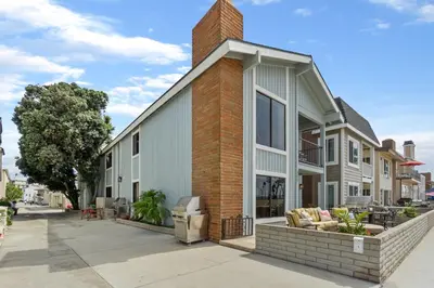 a house with a brick chimney on a street at 3 Bedroom Home in Balboa - Walk to Pier & Restaurants in Newport Beach