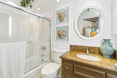 a bathroom with a sink and a toilet and a mirror at 2 Bedroom Home on the Beach with Ocean View in Newport Beach