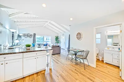 a kitchen and dining room with a table and chairs at Cozy 3 Bedroom Across from Playground on the Beach in Newport Beach