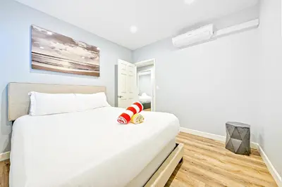 a bedroom with a large white bed in a room at Cozy 3 Bedroom Across from Playground on the Beach in Newport Beach