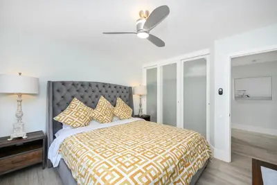 a bedroom with a bed and a ceiling fan at 3 Bedroom home on the beach steps from Balboa Pier in Newport Beach