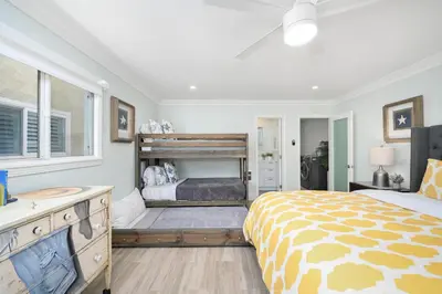 a bedroom with a large bed and a window at 3 Bedroom home on the beach steps from Balboa Pier in Newport Beach