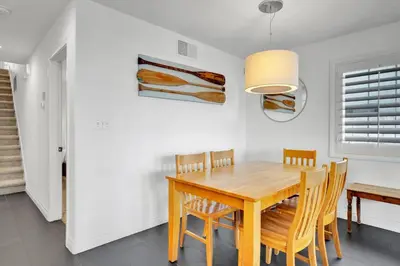 a dining room with a wooden table and chairs at Fantastic bayside vacation home - WiFi, central AC, patio, private washer & dryer in San Diego