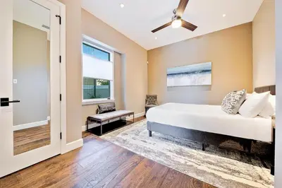 a bedroom with a bed and a ceiling fan at Luxury Bird Rock Home with Private Pool, Hot Tub & Fire Pit! in San Diego