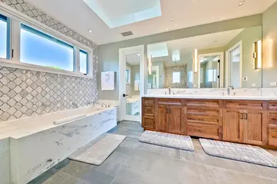 a large bathroom with two sinks and a large mirror at Luxury Bird Rock Home with Private Pool, Hot Tub & Fire Pit! in San Diego
