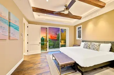 a bedroom with a bed and a ceiling fan at Luxury Bird Rock Home with Private Pool, Hot Tub & Fire Pit! in San Diego