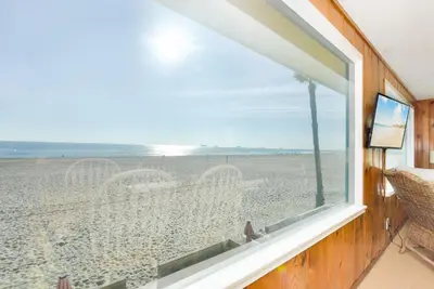 a window with a view of the beach at Upstairs 2 Bedroom Home with Ocean Views on 65th St in Newport Beach