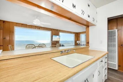 a kitchen with a sink and a large window at Upstairs 2 Bedroom Home with Ocean Views on 65th St in Newport Beach