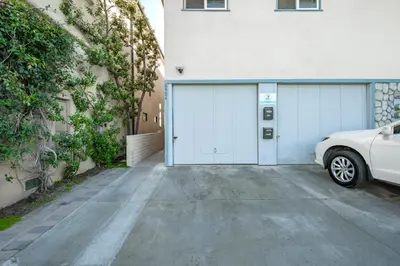 a white car parked in front of a garage at Upstairs 2 Bedroom Home with Ocean Views on 65th St in Newport Beach