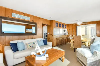 a living room with a couch and a table at Upstairs 2 Bedroom Home with Ocean Views on 65th St in Newport Beach