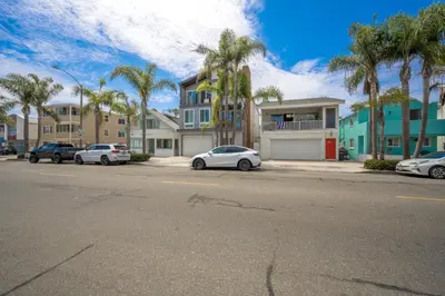 a street with cars parked in front of houses at NEW - 3 Bedroom near the Balboa Pier and Fun Zone with AC in Newport Beach