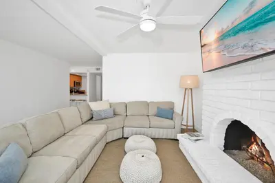 a living room with a couch and a fireplace at NEW - 3 Bedroom near the Balboa Pier and Fun Zone with AC in Newport Beach
