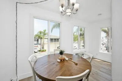 a dining room with a wooden table and chairs at 6 Bedroom Duplex near the Balboa Pier and Fun Zone with AC in Newport Beach