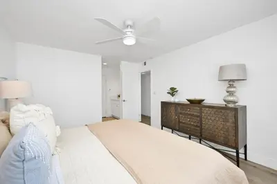 a bedroom with a bed and a ceiling fan at 6 Bedroom Duplex near the Balboa Pier and Fun Zone with AC in Newport Beach